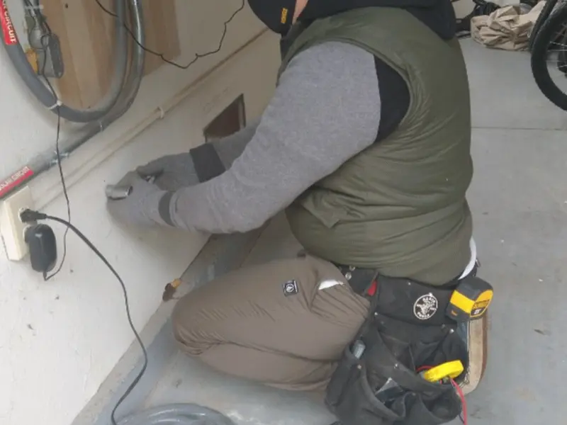 Electrician performing outlet wiring in a Swoyersville garage